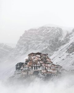 Key Monastery enveloped in winter snow in the serene Himalayas. A misty, cold landscape of beauty and tranquility.